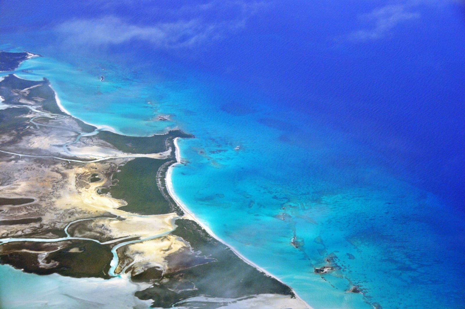 Aerial view of Shroud Cay's mangrove creeks on one side and a beach on the Exuma Sound side