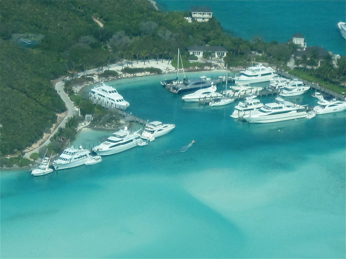 Aerial view of yachts docked at Sampson Cay marina among turquoise Exuma water