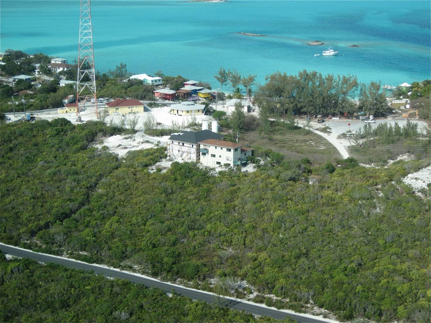 Aerial view of Staniel Cay village with turquoise water and a moored yacht