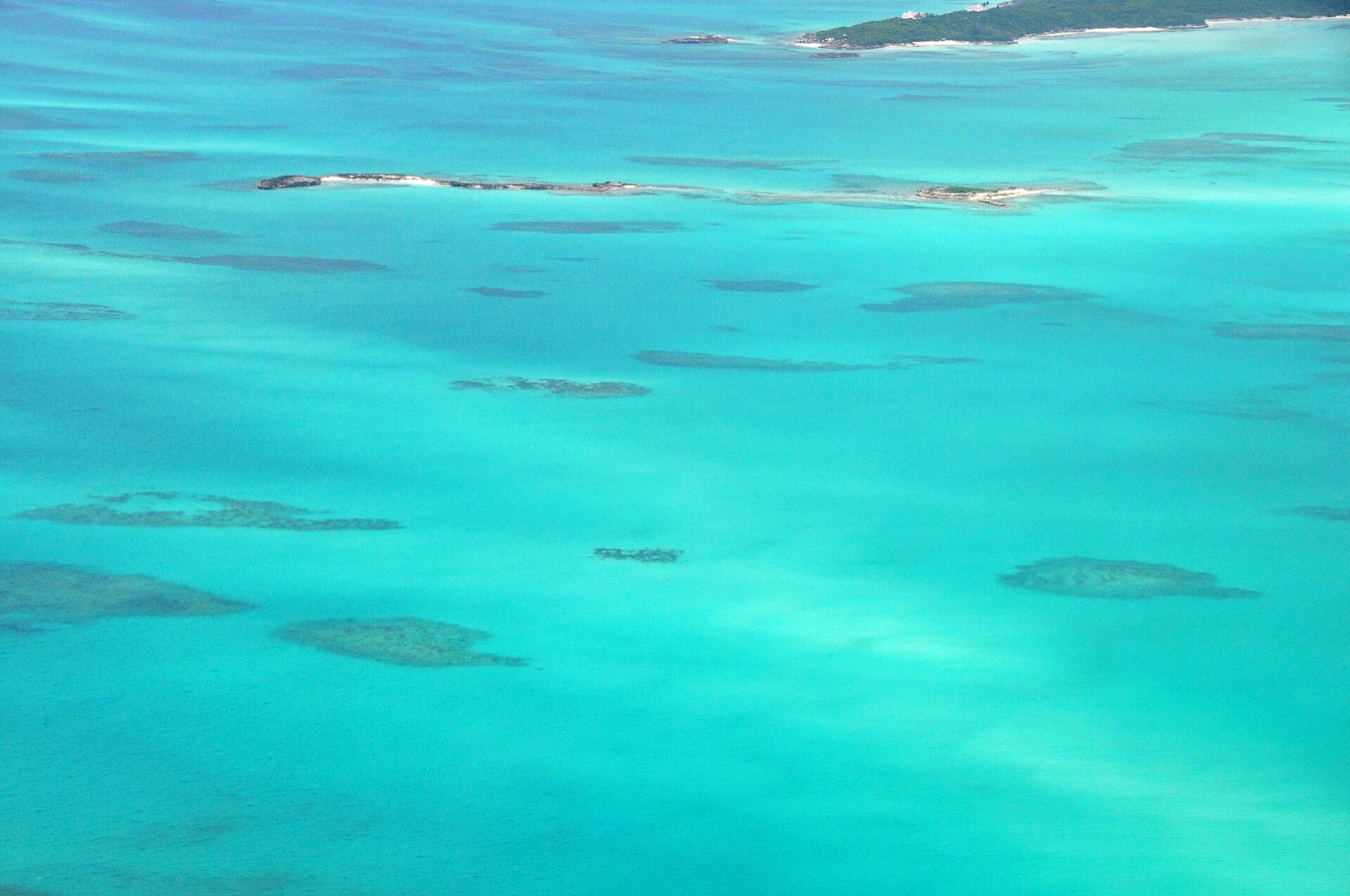 Aerial view of shallow patch reefs in turquoise water off Great Exuma, near Hoopers Bay