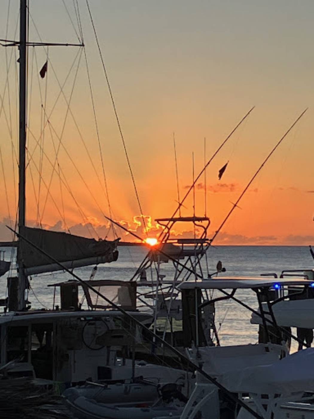 Sunrise behind moored fishing boats at the Staniel Cay marina
